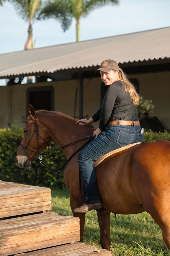 Erin smiling from the saddle beside the mounting block